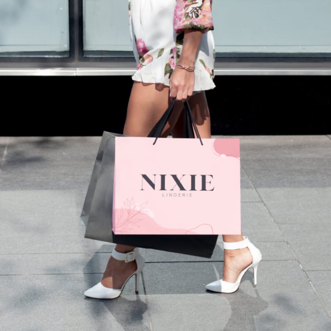 Woman with shopping bag from Nixie Lingerie store.